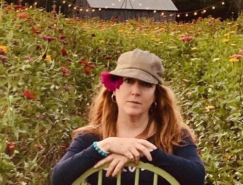 woman flower in long hair at flower farm